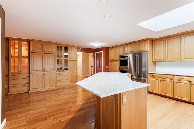 7175 Gale Rd, Lima, NY 14485 - kitchen with stainless steel appliances, a skylight, light wood-type flooring, a kitchen island, and recessed lighting