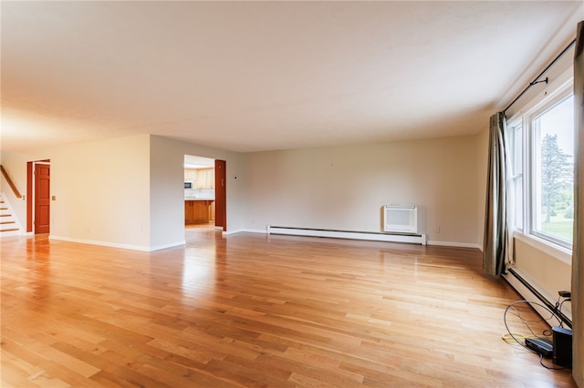7175 Gale Rd, Lima, NY 14485 - spare room featuring a baseboard radiator, light wood finished floors, and stairway