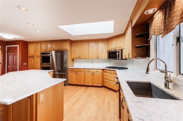 7175 Gale Rd, Lima, NY 14485 - kitchen with stainless steel appliances, a skylight, light stone counters, open shelves, and light wood-type flooring