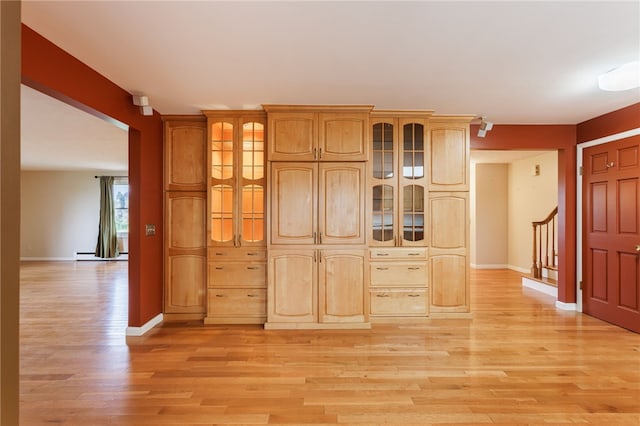 7175 Gale Rd, Lima, NY 14485 - kitchen with light wood-style flooring, glass insert cabinets, and a baseboard heating unit