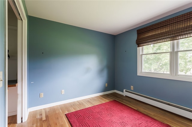 7175 Gale Rd, Lima, NY 14485 - spare room with a baseboard radiator and wood finished floors