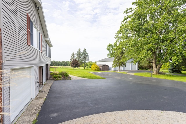 7175 Gale Rd, Lima, NY 14485 - view of patio with a garage and asphalt driveway
