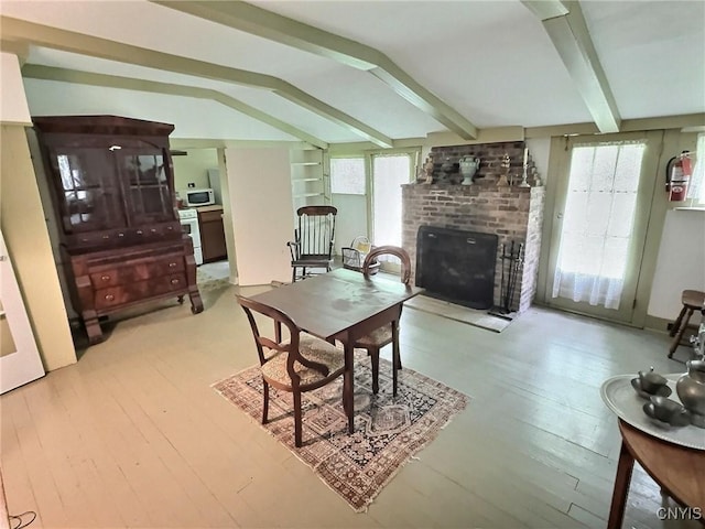 326 Main St, Ledyard, NY 13026 - dining area featuring a brick fireplace, plenty of natural light, and light wood-style flooring