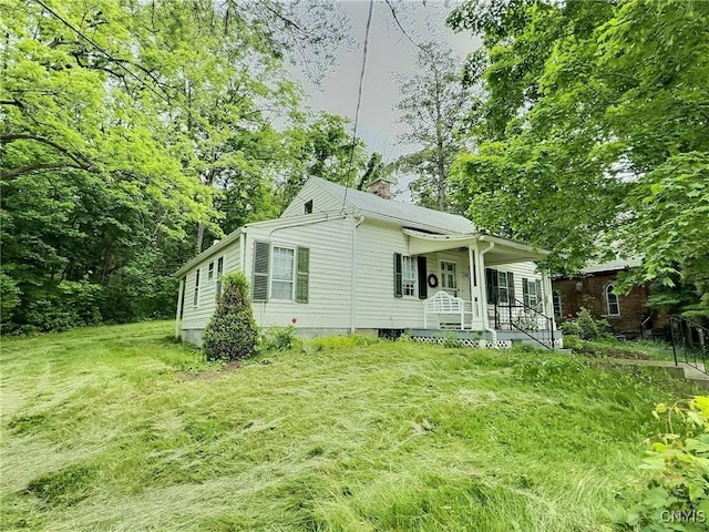 326 Main St, Ledyard, NY 13026 - view of property exterior with a chimney, covered porch, and a yard