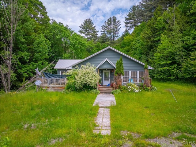 7460 State Highway 29, Oppenheim, NY 13329 - view of front facade with a view of trees, a metal roof, and a wooden deck