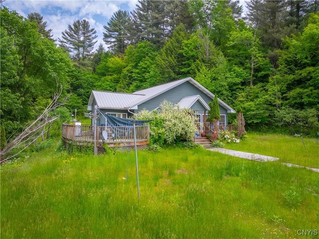 7460 State Highway 29, Oppenheim, NY 13329 - view of front of home with a deck, a metal roof, and a wooded view
