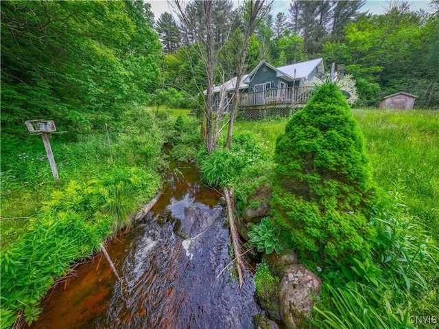 7460 State Highway 29, Oppenheim, NY 13329 - view of yard with a wooden deck, a storage shed, and a forest view