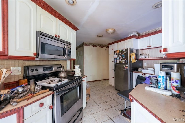 7460 State Highway 29, Oppenheim, NY 13329 - kitchen with stainless steel appliances, light tile patterned flooring, decorative backsplash, and white cabinets
