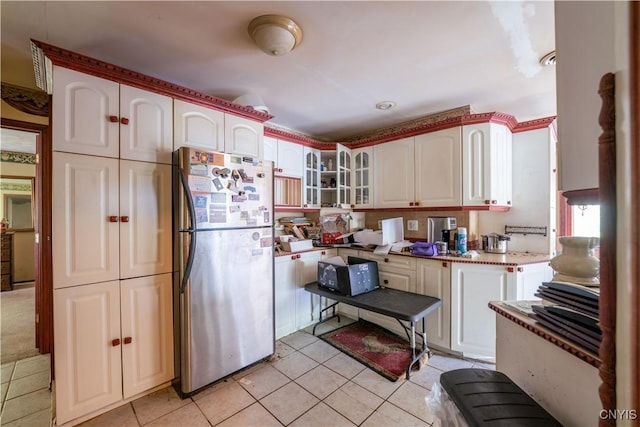 7460 State Highway 29, Oppenheim, NY 13329 - kitchen with freestanding refrigerator, light tile patterned floors, glass insert cabinets, and white cabinets