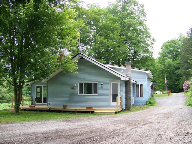 236 Covered Bridge Rd, Davenport, NY 13820 - view of front facade featuring a chimney, dirt driveway, and a deck