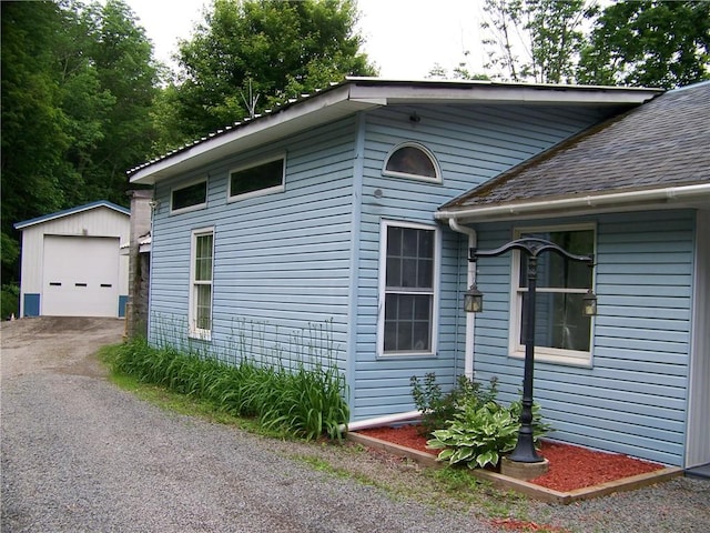 236 Covered Bridge Rd, Davenport, NY 13820 - view of side of home with an outdoor structure, asphalt driveway, a detached garage, and roof with shingles