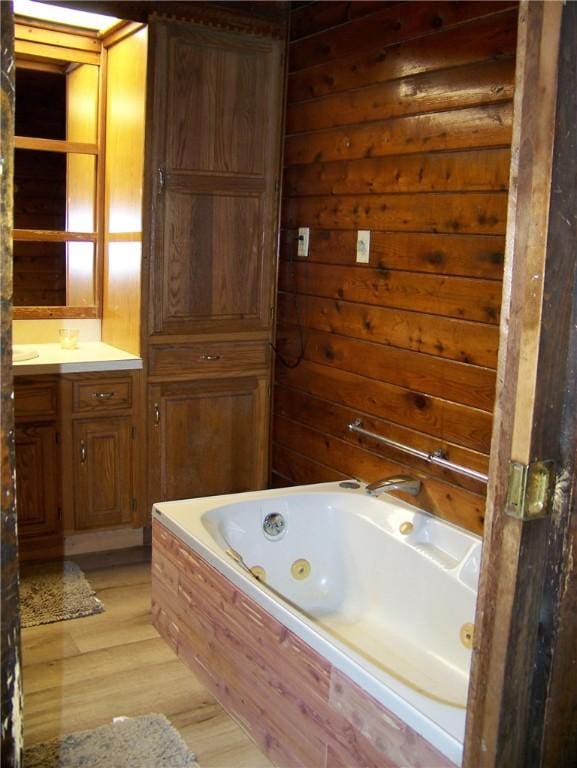 236 Covered Bridge Rd, Davenport, NY 13820 - full bathroom with a tub with jets, wood finished floors, and vanity