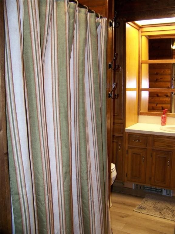 236 Covered Bridge Rd, Davenport, NY 13820 - full bathroom with wood finished floors, vanity, and a shower with curtain