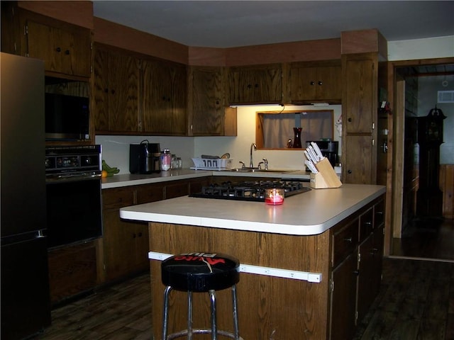 236 Covered Bridge Rd, Davenport, NY 13820 - kitchen with black appliances, dark wood-style floors, light countertops, and a kitchen island