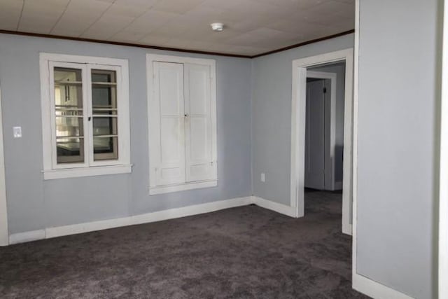 109 S Madison Ave, Dix, NY 14891 - empty room featuring dark colored carpet, crown molding, and a smoke detector