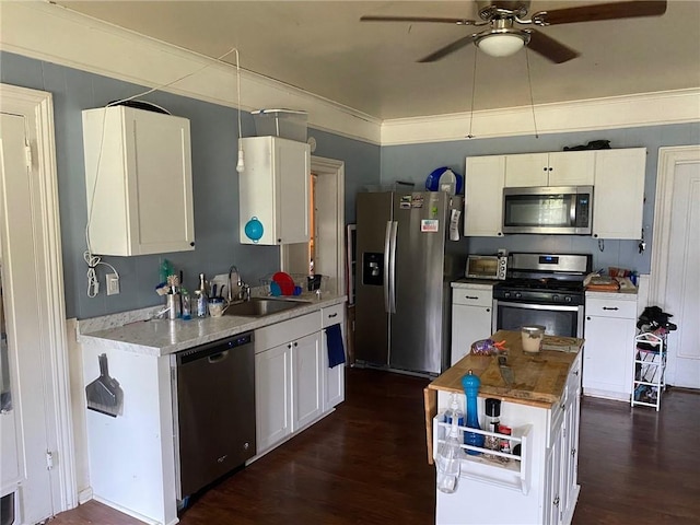 25 N Academy St, Middlebury, NY 14591 - kitchen with stainless steel appliances, a ceiling fan, white cabinets, dark wood-style floors, and ornamental molding
