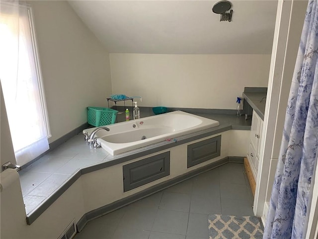 25 N Academy St, Middlebury, NY 14591 - bathroom with vaulted ceiling, a whirlpool tub, tile patterned floors, and vanity
