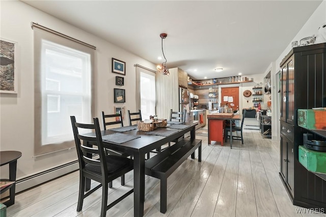 228 Potomac Ave, Buffalo, NY 14213 - dining room featuring a baseboard radiator and light wood finished floors