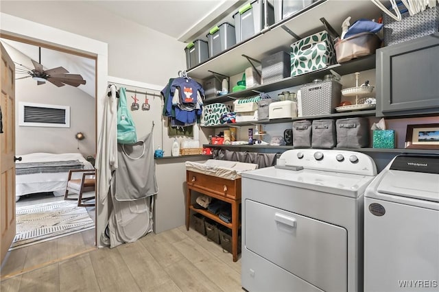 228 Potomac Ave, Buffalo, NY 14213 - washroom featuring washing machine and dryer, cabinet space, light wood-style floors, and a ceiling fan