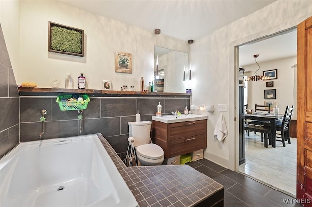 228 Potomac Ave, Buffalo, NY 14213 - bathroom with vanity, a bathtub, tile patterned flooring, and a chandelier