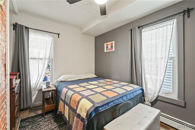 228 Potomac Ave, Buffalo, NY 14213 - bedroom featuring baseboard heating, wood finished floors, and ceiling fan