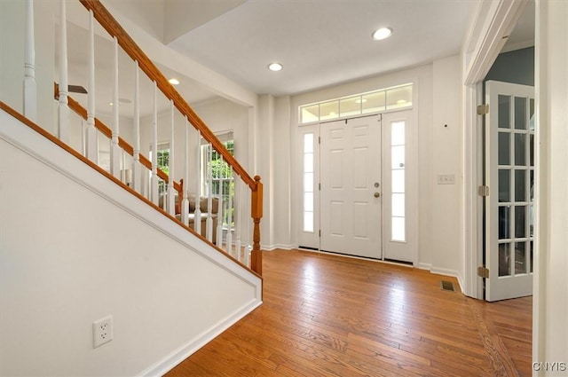 8278 Luchsinger Ln, Lysander, NY 13027 - entryway with wood-type flooring, recessed lighting, and stairway
