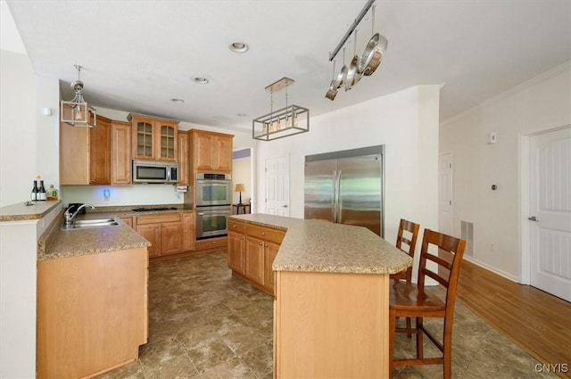 8278 Luchsinger Ln, Lysander, NY 13027 - kitchen featuring appliances with stainless steel finishes, a kitchen breakfast bar, a center island, glass insert cabinets, and decorative light fixtures