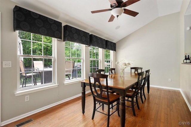 8278 Luchsinger Ln, Lysander, NY 13027 - dining room with lofted ceiling, wood finished floors, and a ceiling fan