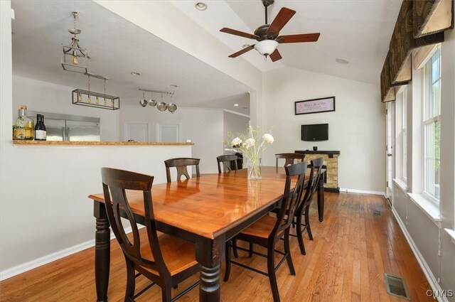 8278 Luchsinger Ln, Lysander, NY 13027 - dining area featuring vaulted ceiling, ceiling fan, and wood-type flooring
