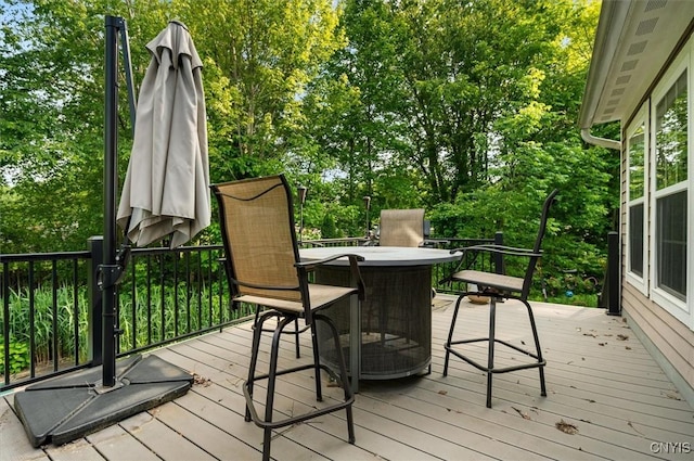 8278 Luchsinger Ln, Lysander, NY 13027 - wooden deck featuring outdoor dining space and view of scattered trees