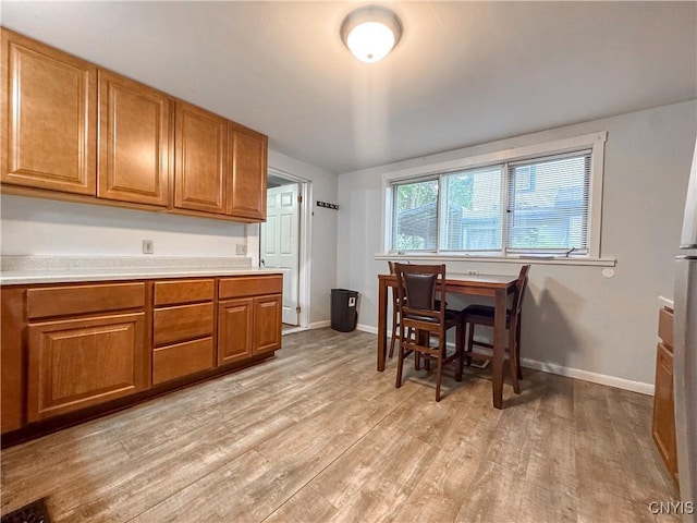 22 Frank St, Cortland, NY 13045 - kitchen with brown cabinets, light wood-type flooring, and light countertops