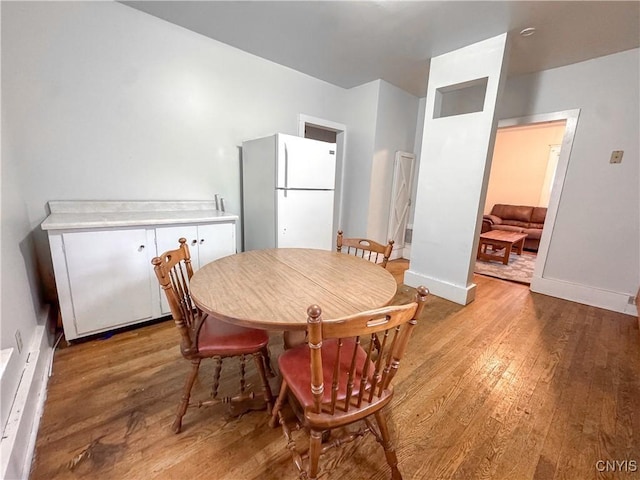 22 Frank St, Cortland, NY 13045 - dining room with light wood-type flooring and baseboards