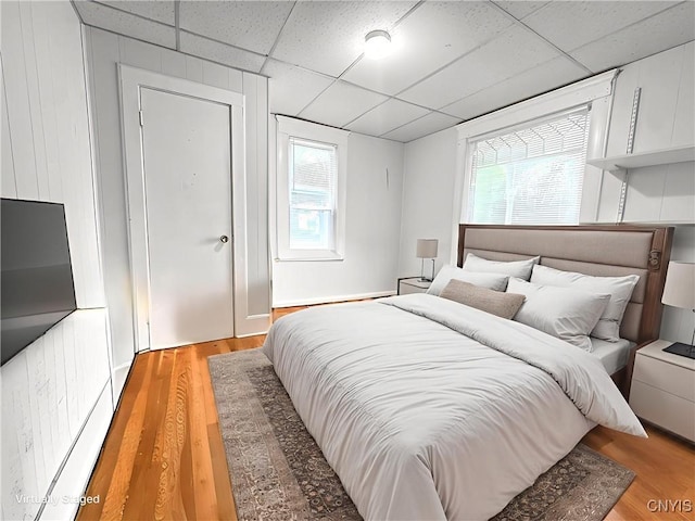 22 Frank St, Cortland, NY 13045 - bedroom featuring a drop ceiling, light wood finished floors, and multiple windows