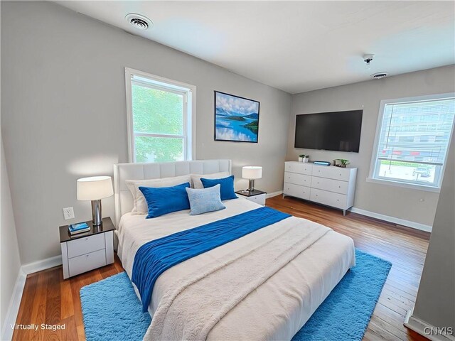 19 Water St, Cortland, NY 13045 - bedroom featuring multiple windows and wood finished floors