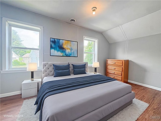 19 Water St, Cortland, NY 13045 - bedroom with lofted ceiling and wood finished floors