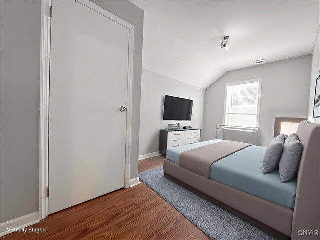 19 Water St, Cortland, NY 13045 - bedroom with lofted ceiling and wood finished floors