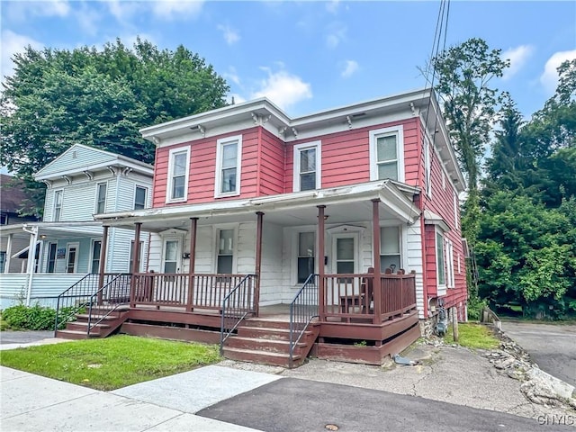 72 Groton Ave, Cortland, NY 13045 - italianate house featuring a porch