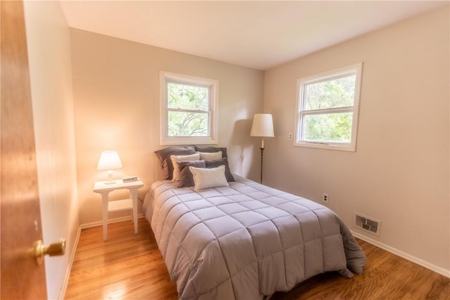 1100 Hatch Rd, Webster, NY 14580 - bedroom with multiple windows and wood finished floors