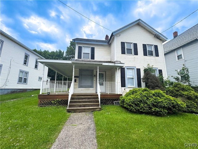 73 Groton Ave Unit 69-71, Cortland, NY 13045 - view of front of house with a porch and a front lawn