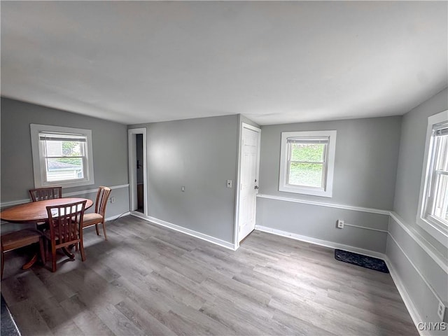 73 Groton Ave Unit 69-71, Cortland, NY 13045 - dining space featuring healthy amount of natural light and wood finished floors