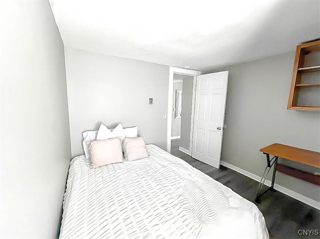 73 Groton Ave Unit 69-71, Cortland, NY 13045 - bedroom featuring baseboards and dark wood-style floors