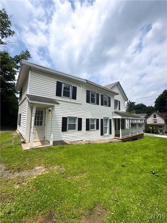 73 Groton Ave Unit 69-71, Cortland, NY 13045 - back of house featuring a lawn