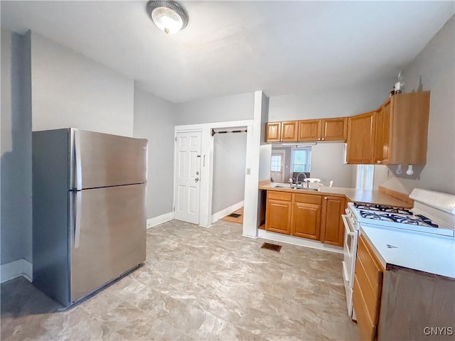 73 Groton Ave Unit 69-71, Cortland, NY 13045 - kitchen with freestanding refrigerator, white gas range, and light countertops