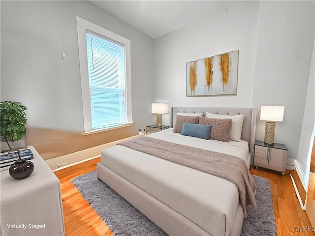 73 Groton Ave Unit 69-71, Cortland, NY 13045 - bedroom with multiple windows and wood finished floors