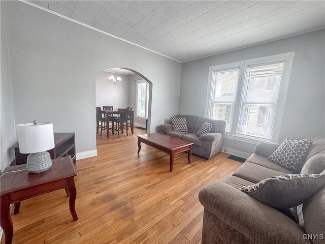 73 Groton Ave Unit 69-71, Cortland, NY 13045 - living room with arched walkways, ornamental molding, light wood-style floors, and a chandelier
