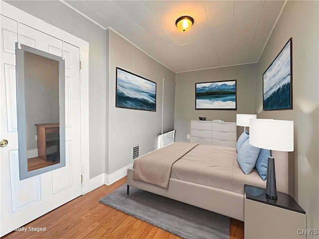 73 Groton Ave Unit 69-71, Cortland, NY 13045 - bedroom featuring wood finished floors and ornamental molding