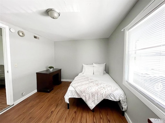 66 Groton Ave, Cortland, NY 13045 - bedroom featuring wood finished floors and multiple windows