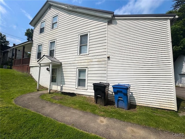 66 Groton Ave, Cortland, NY 13045 - rear view of house featuring a lawn