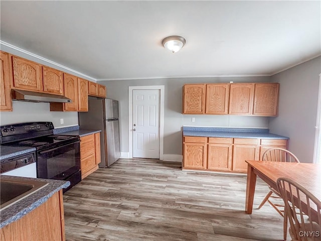 66 Groton Ave, Cortland, NY 13045 - kitchen with under cabinet range hood, black range with electric stovetop, freestanding refrigerator, crown molding, and light wood finished floors