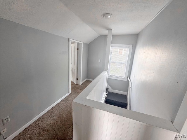 66 Groton Ave, Cortland, NY 13045 - hallway with lofted ceiling, carpet flooring, a textured ceiling, and an upstairs landing